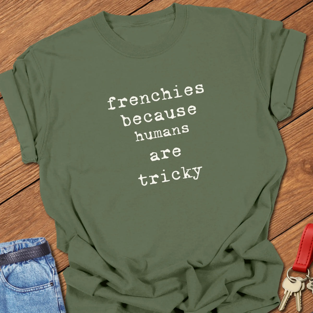 Moss Comfort Colors French Bulldog t-shirt featuring the phrase "Humans Are Tricky" in vintage ivory typewriter typography.