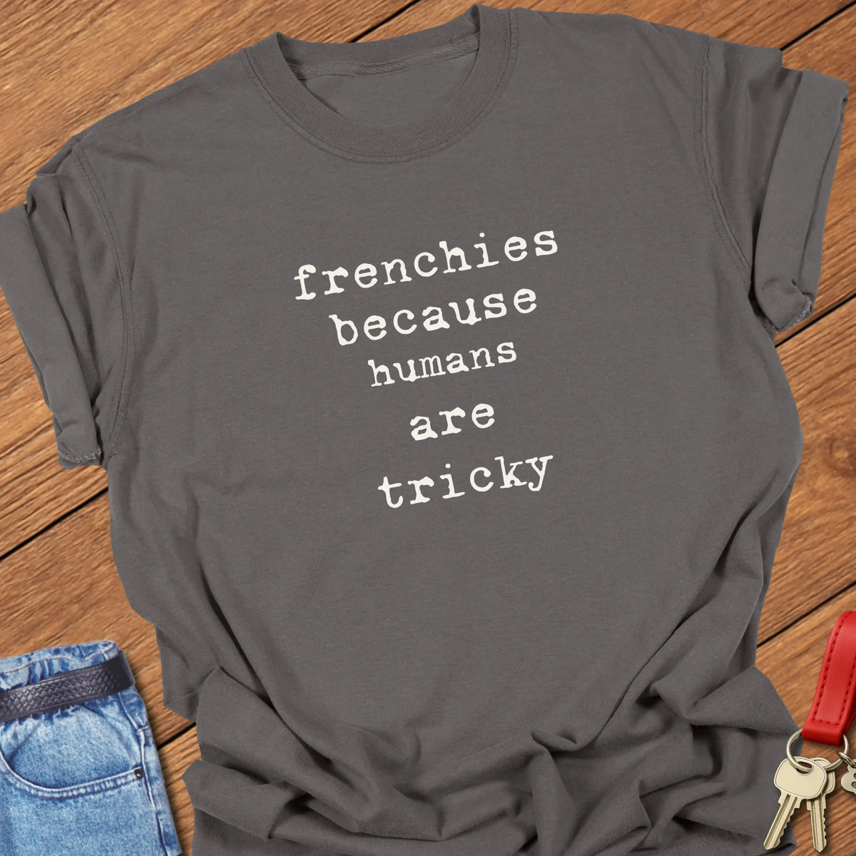 Pepper Comfort Colors French Bulldog t-shirt featuring the phrase "Humans Are Tricky" in vintage ivory typewriter typography.