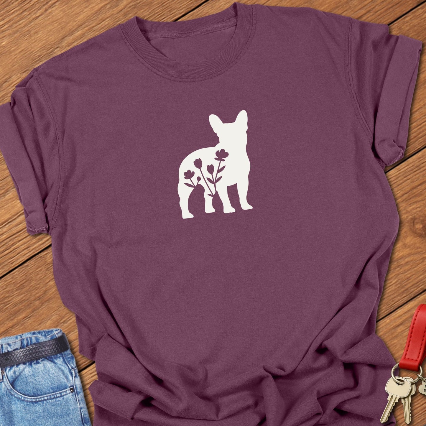 French bulldog silhouette with floral negative space design printed on berry Comfort Colors t shirt