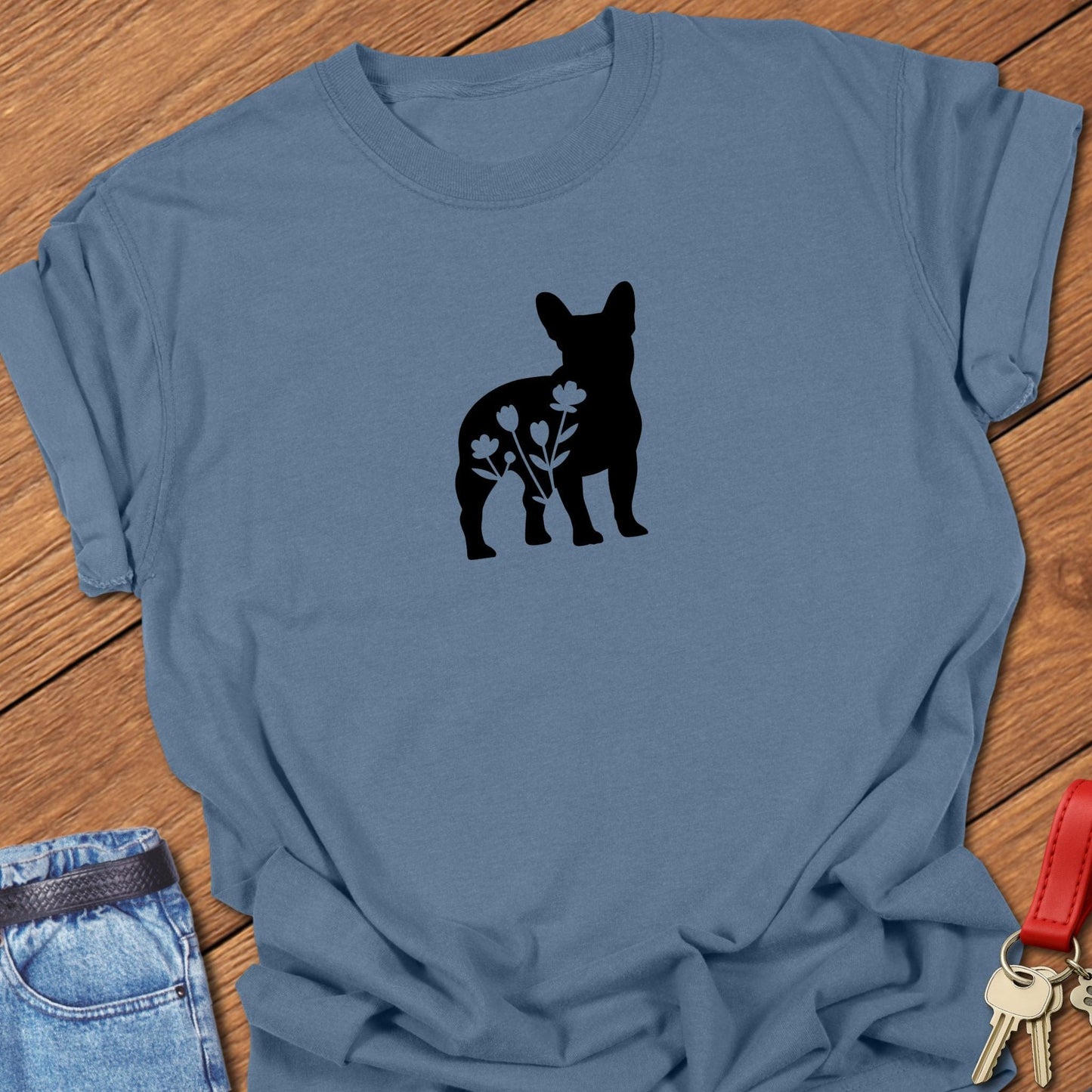 French bulldog silhouette with floral negative space design printed on blue jean Comfort Colors t shirt
