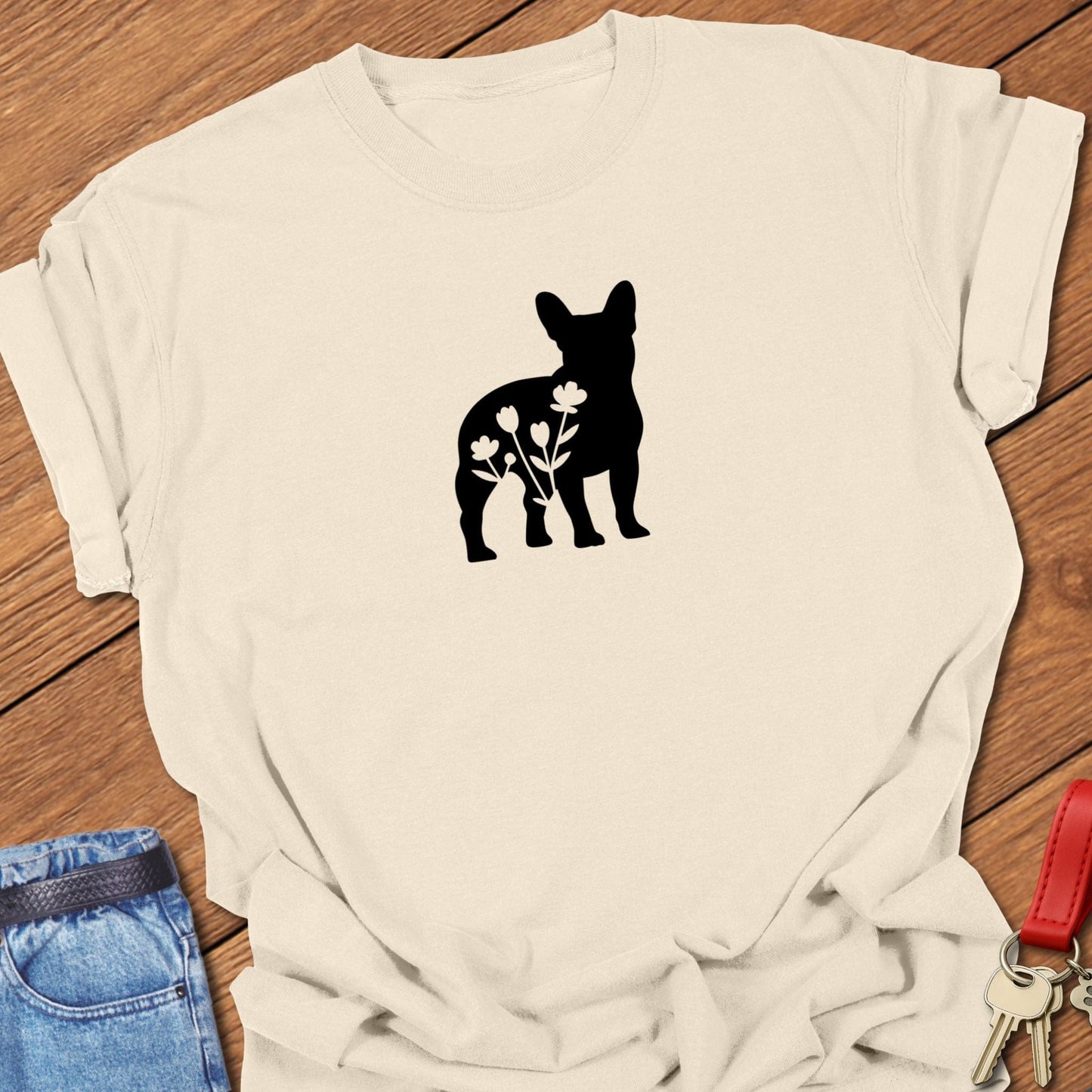 French bulldog silhouette with floral cutout design printed on ivory Comfort Colors t shirt.
