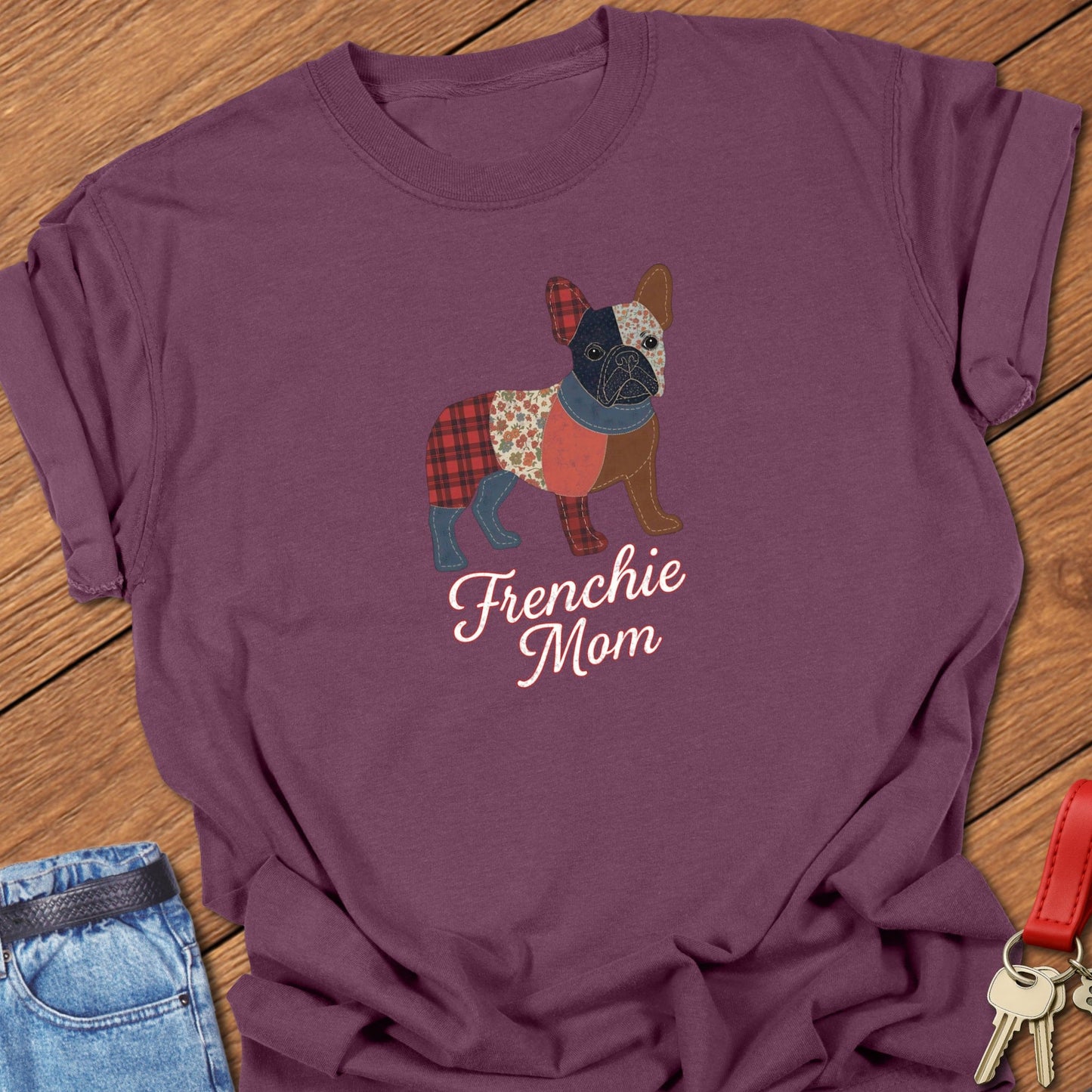 French bulldog patchwork-style illustration with mixed fabric textures and “Frenchie Mom” lettering printed on black Comfort Colors t shirt