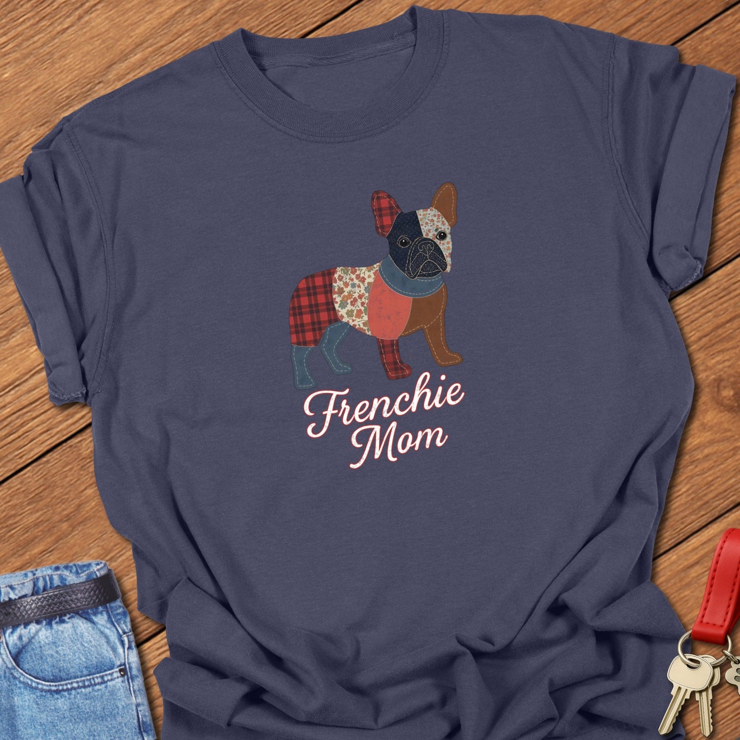French bulldog patchwork-style illustration with mixed fabric textures and “Frenchie Mom” lettering printed on navy Comfort Colors t shirt