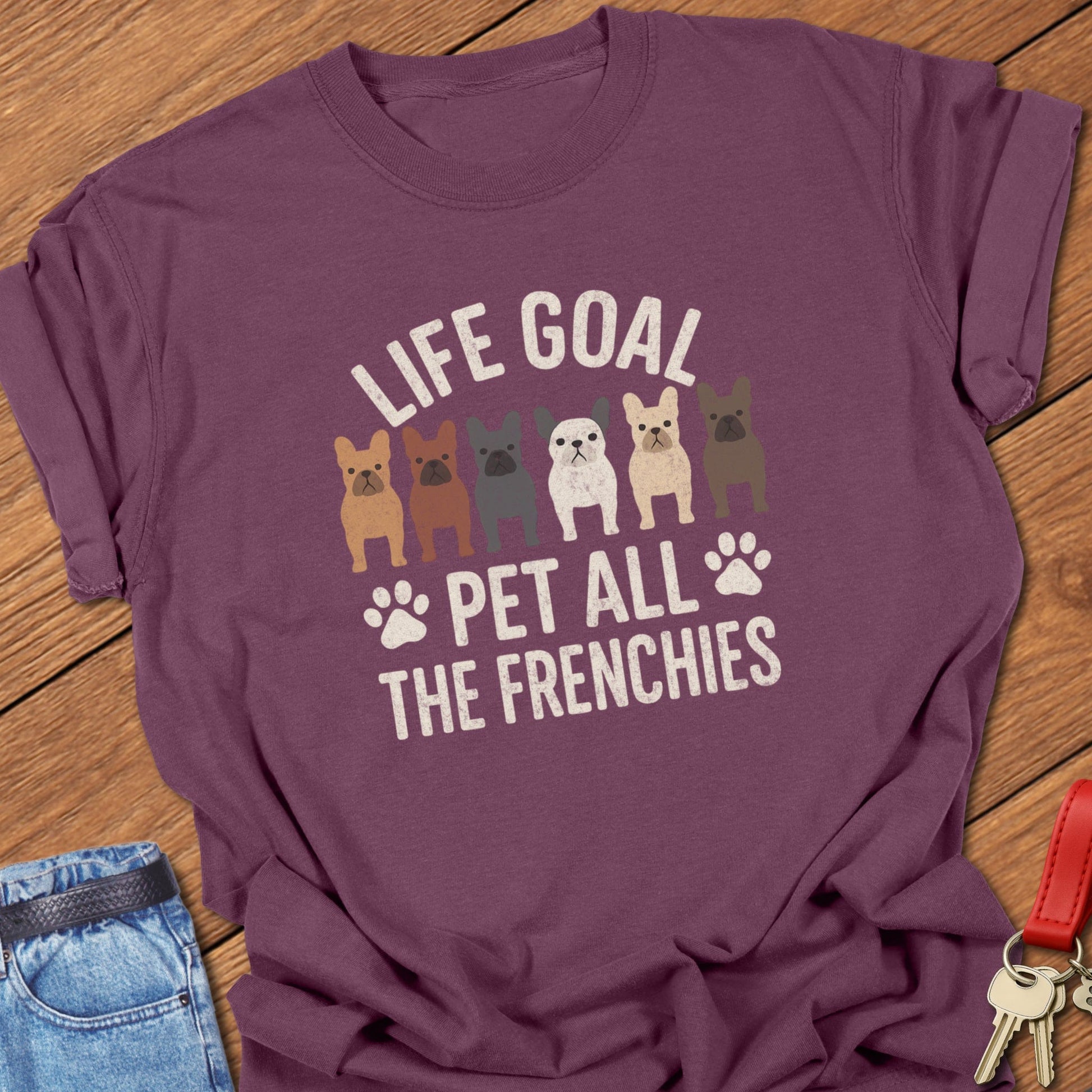 French bulldog pet lover illustration with multiple Frenchie graphics and life goal typography printed on berry Comfort Colors t shirt