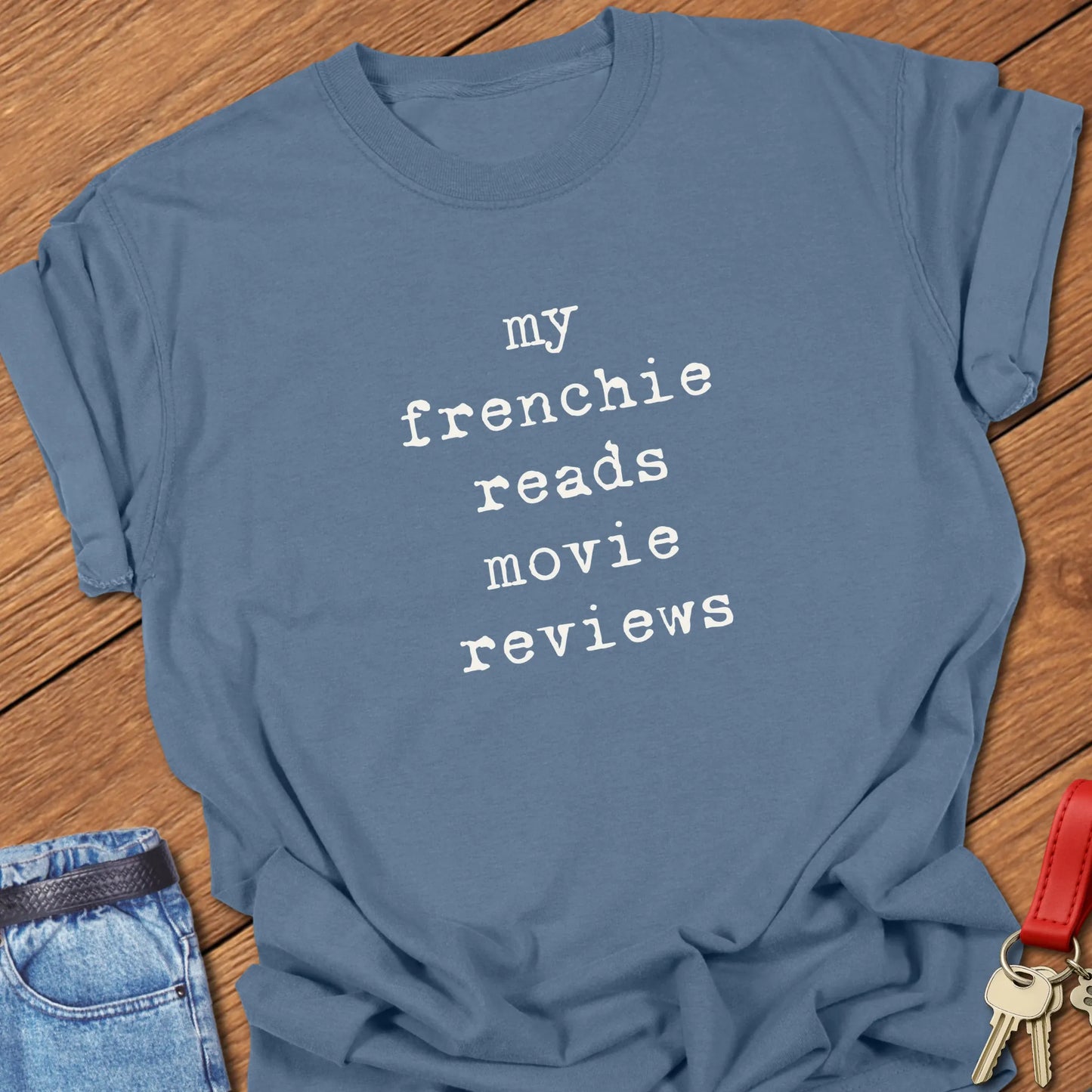 French Bulldog t-shirt featuring the slogan "My Frenchie Reads Movie Reviews" printed on a Comfort Colors® garment-dyed t-shirt in Blue Jean color.