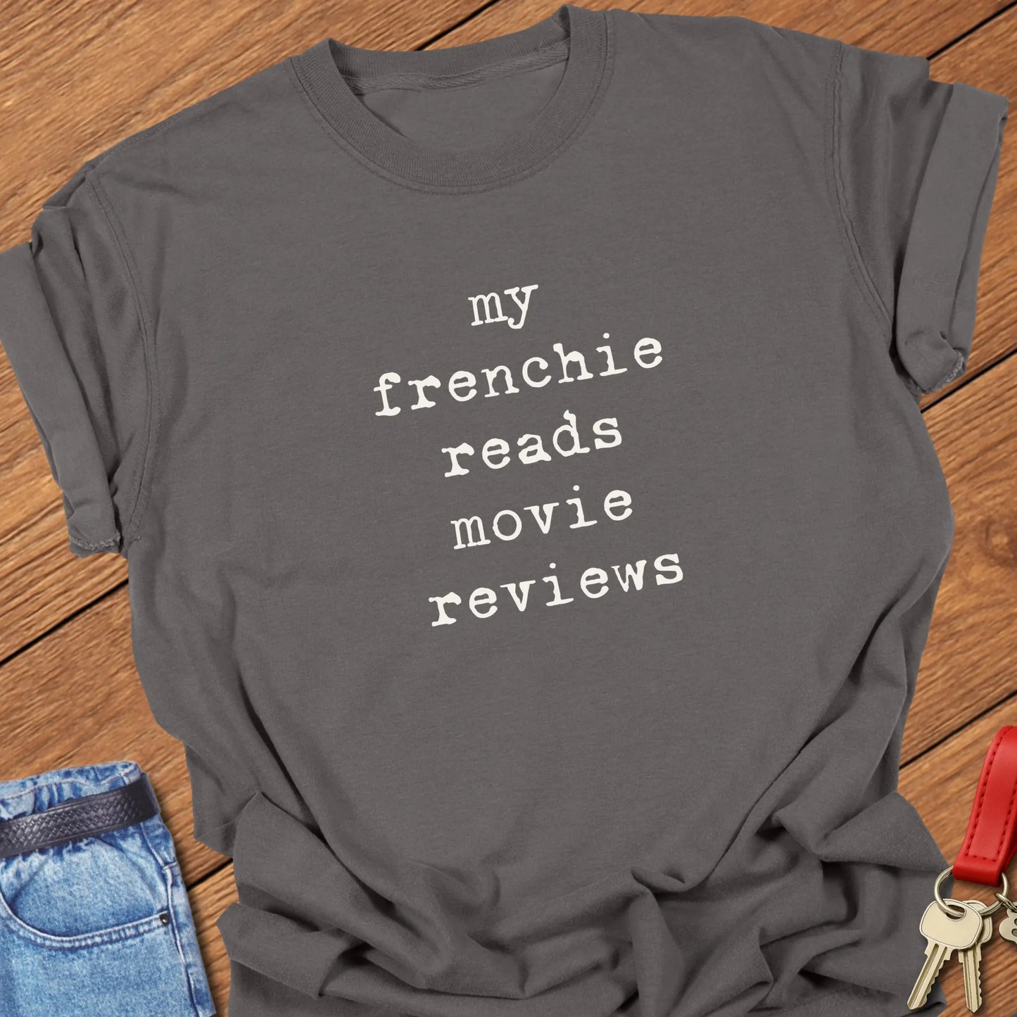 French Bulldog t-shirt featuring the slogan "My Frenchie Reads Movie Reviews" printed on a Comfort Colors® garment-dyed t-shirt in Espresso color.