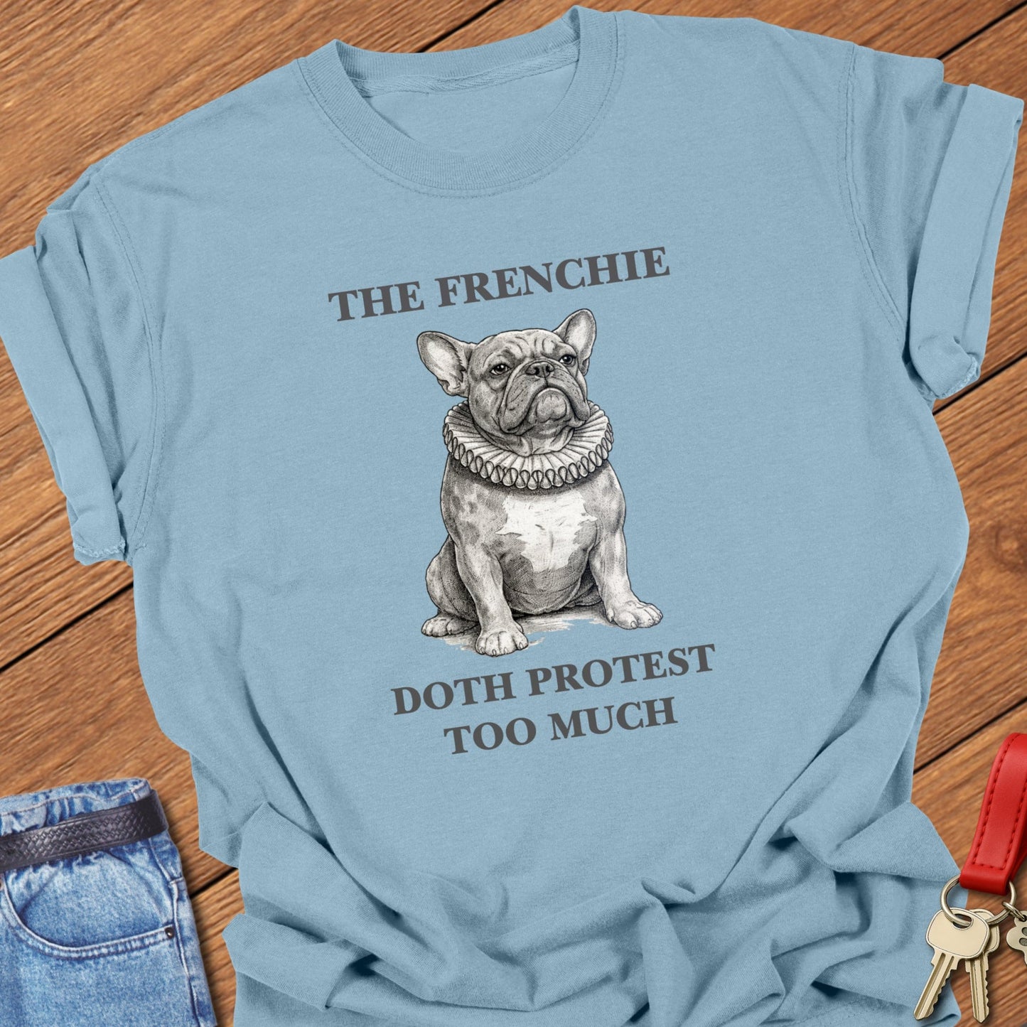 French bulldog vintage engraved illustration with ruffled collar and humorous text printed on ice blue Comfort Colors t shirt.