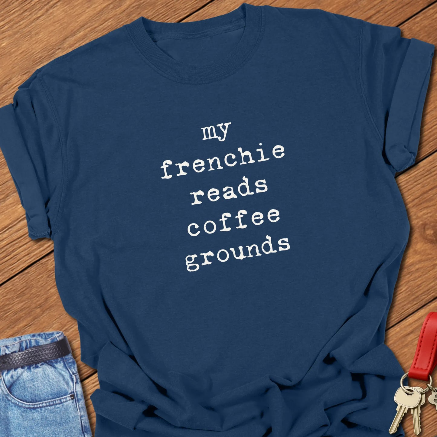 Typewriter-style typography featuring the slogan "My Frenchie Reads Coffee Grounds" printed on a Comfort Colors® garment-dyed t-shirt in True Navy color.