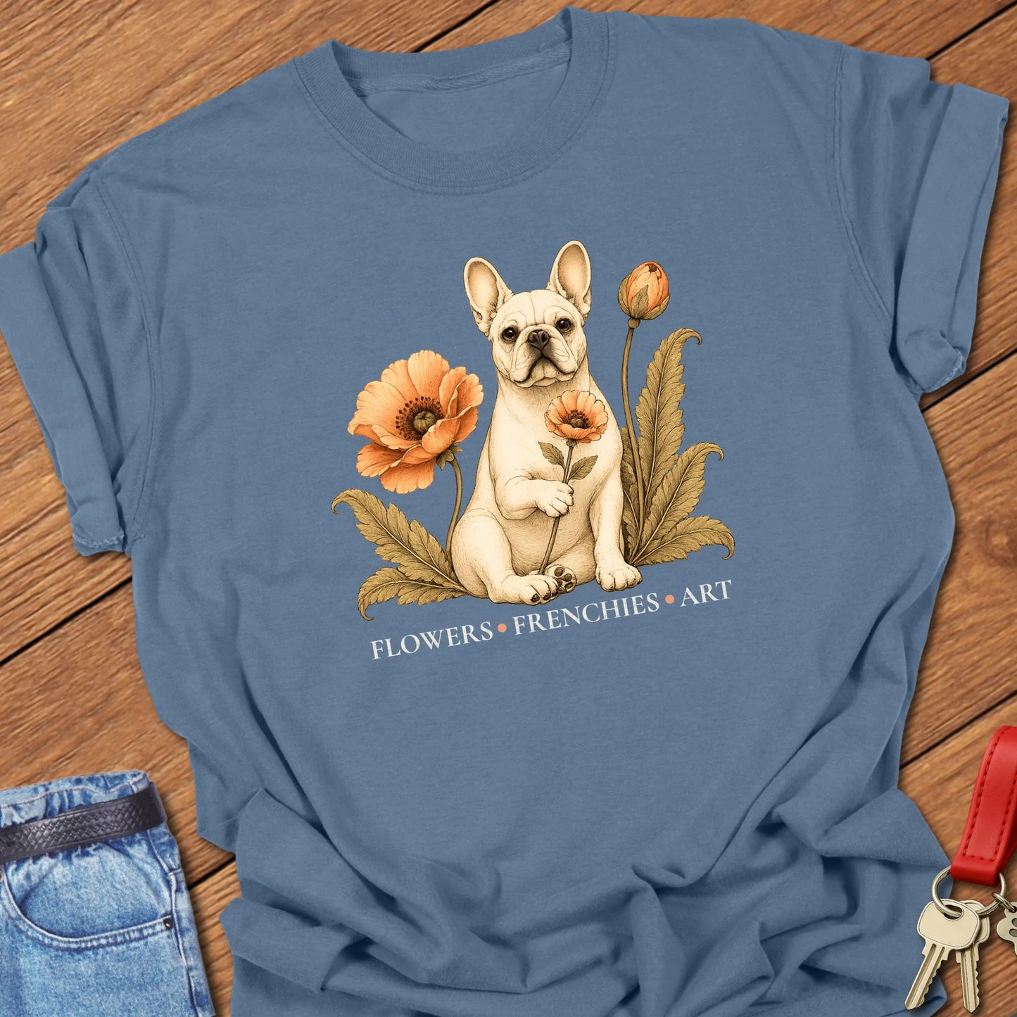 Cream French Bulldog surrounded by vintage-inspired poppy flowers and botanical foliage with the phrase "Flowers • Frenchies • Art" printed on a Comfort Colors® garment-dyed t-shirt in Blue Jean color.