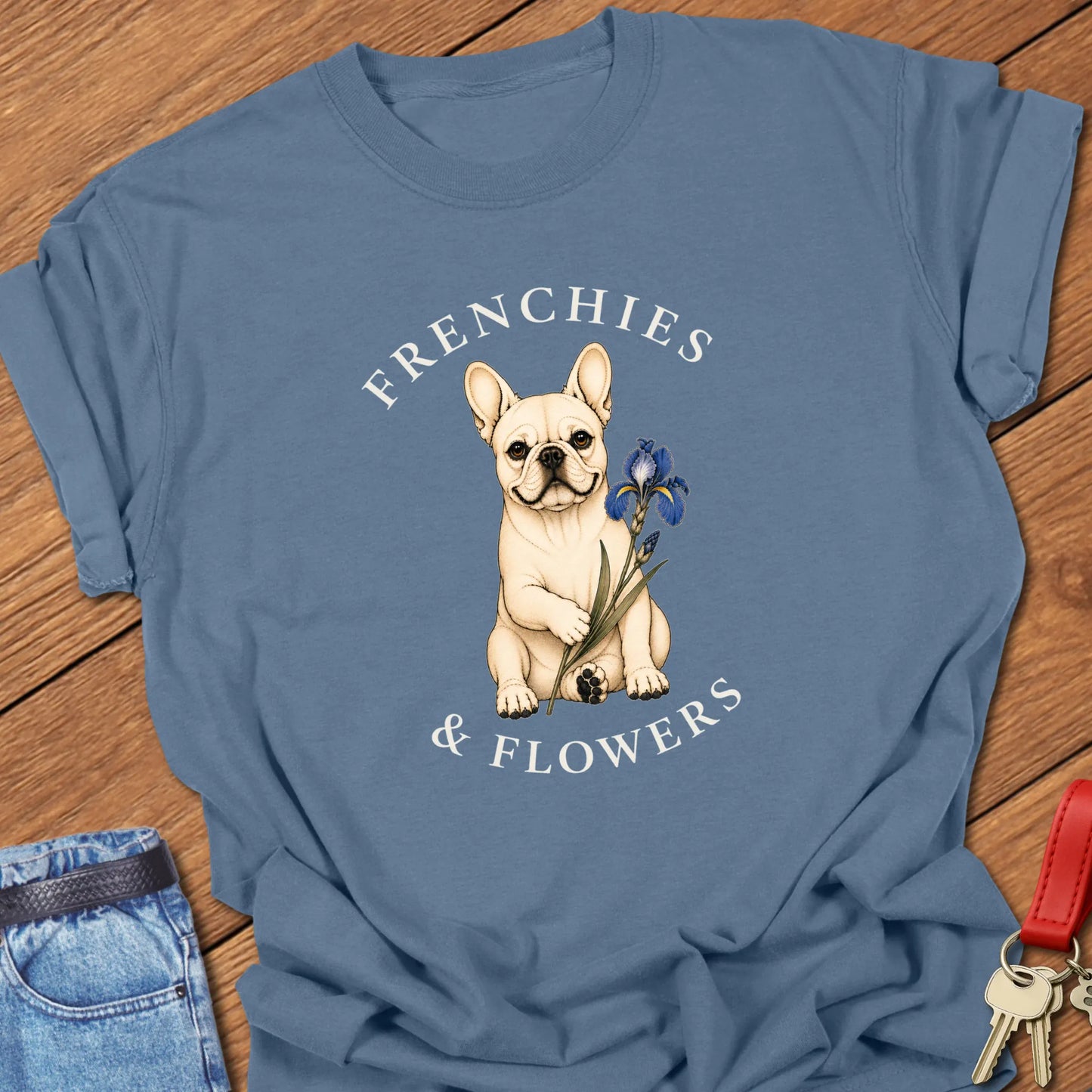 Frenchie Blue Iris botanical French Bulldog illustration with blue iris flower and Frenchies & Flowers typography printed on Comfort Colors® t-shirt in Blue Jean Color
