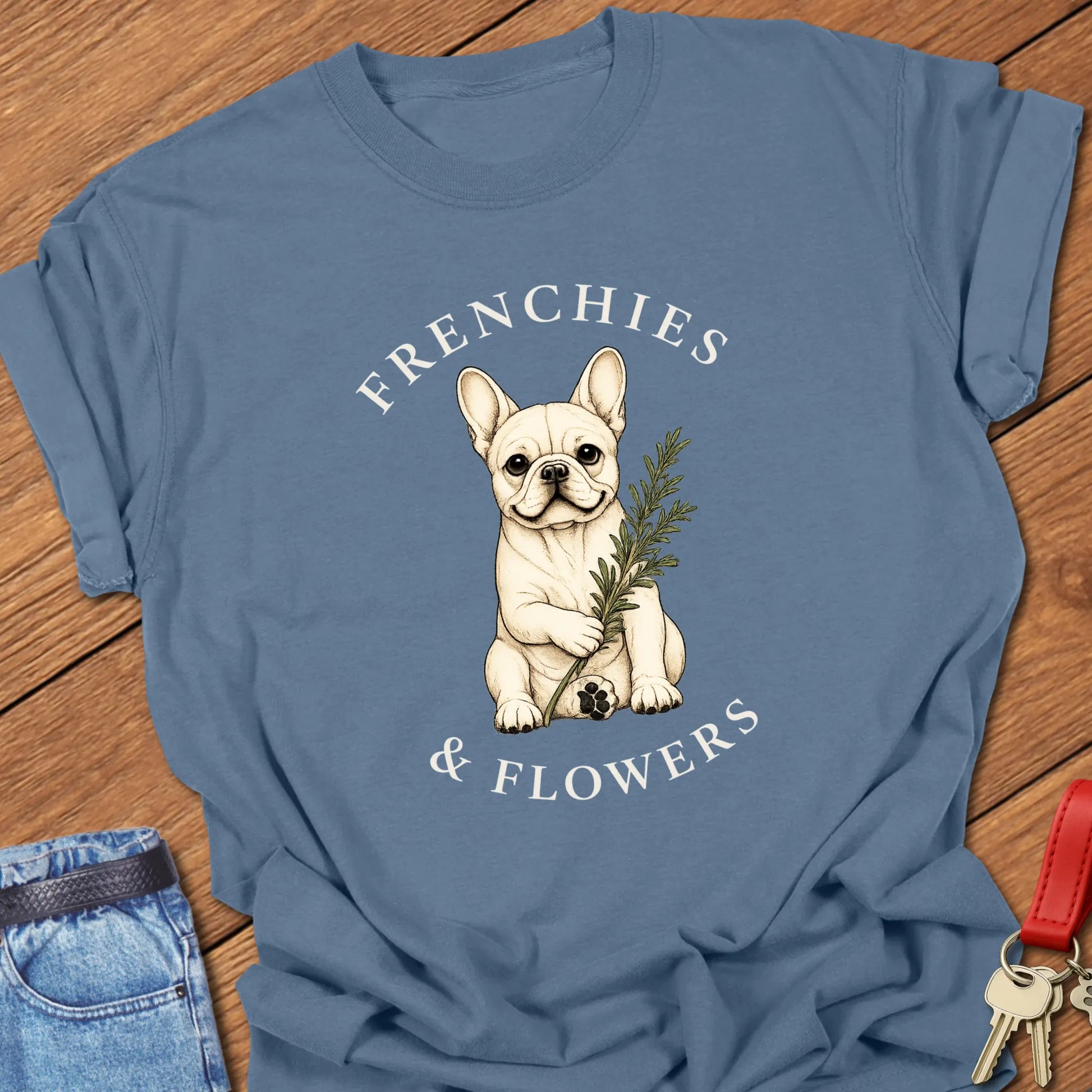 Frenchie Rosemary botanical French Bulldog illustration with rosemary sprig and Frenchies & Flowers typography printed on Comfort Colors® t-shirt in Blue Jean Color