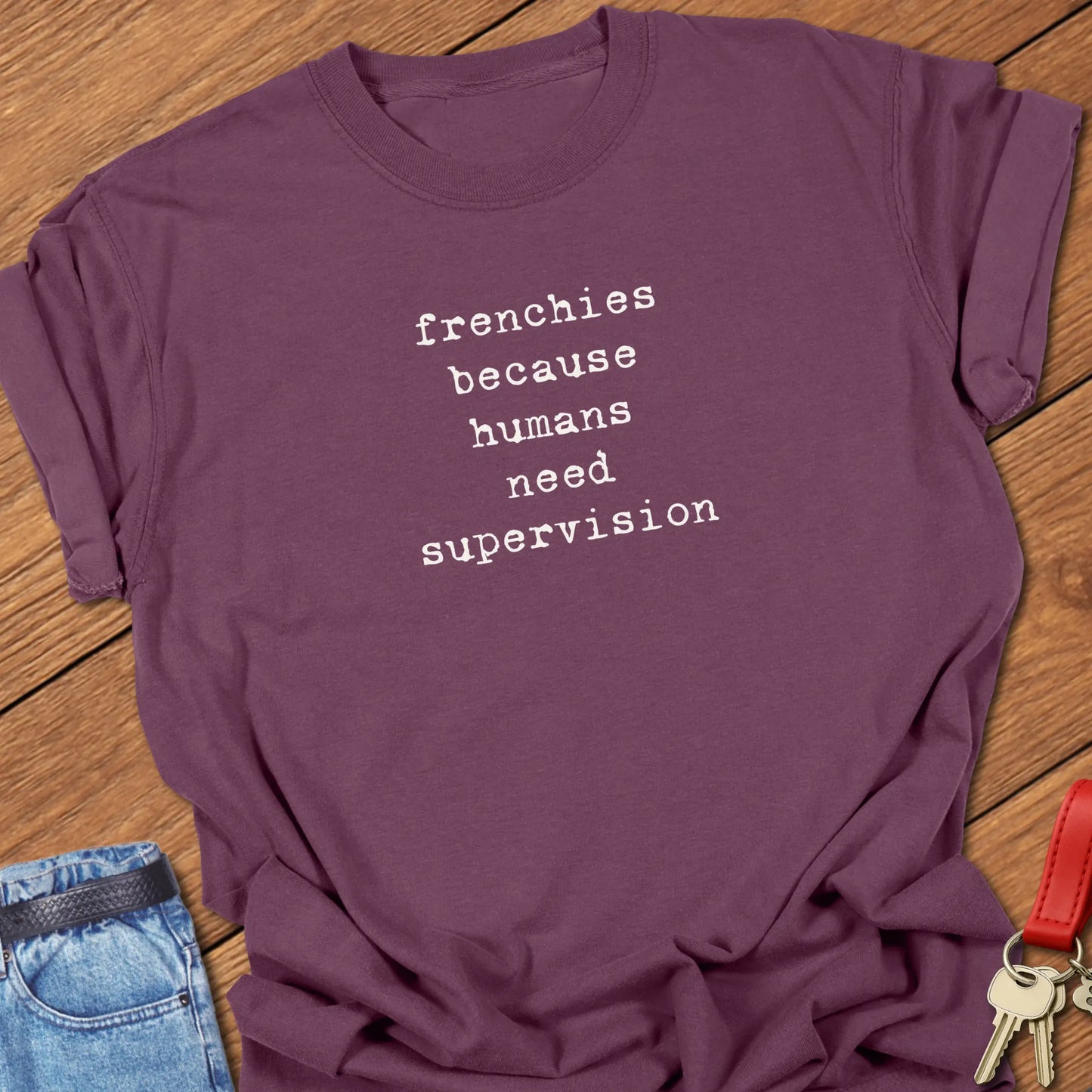 Frenchie Supervision t-shirt displayed on a Berry Comfort Colors® garment-dyed tee with minimalist serif typography featuring the funny saying "Frenchies because humans need supervision."