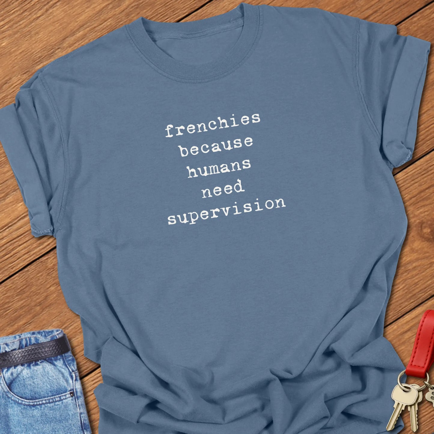 Frenchie Supervision t-shirt displayed on a Blue Jean Comfort Colors® garment-dyed tee with minimalist serif typography featuring the funny saying "Frenchies because humans need supervision."