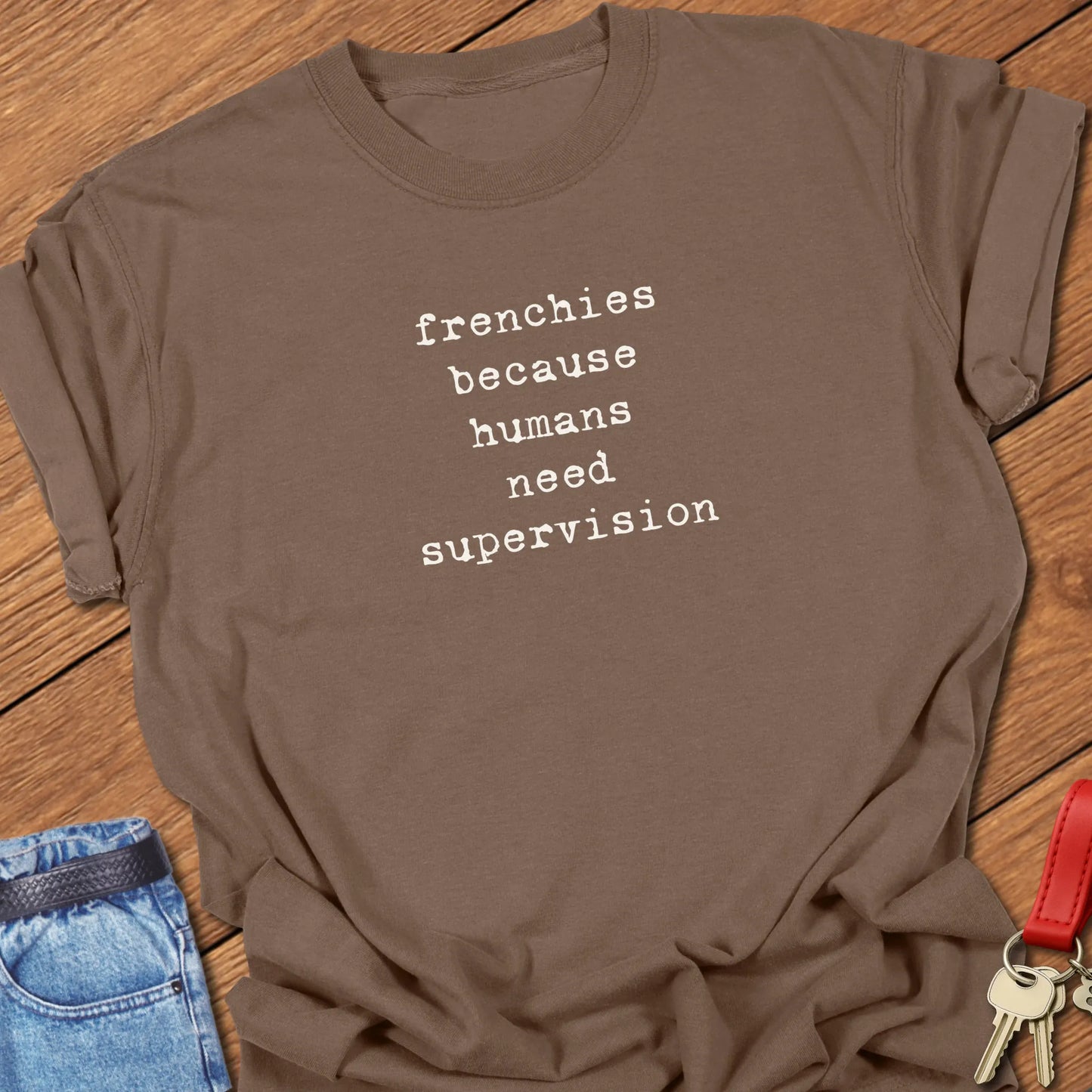 Frenchie Supervision t-shirt displayed on a Espresso Comfort Colors® garment-dyed tee with minimalist serif typography featuring the funny saying "Frenchies because humans need supervision."