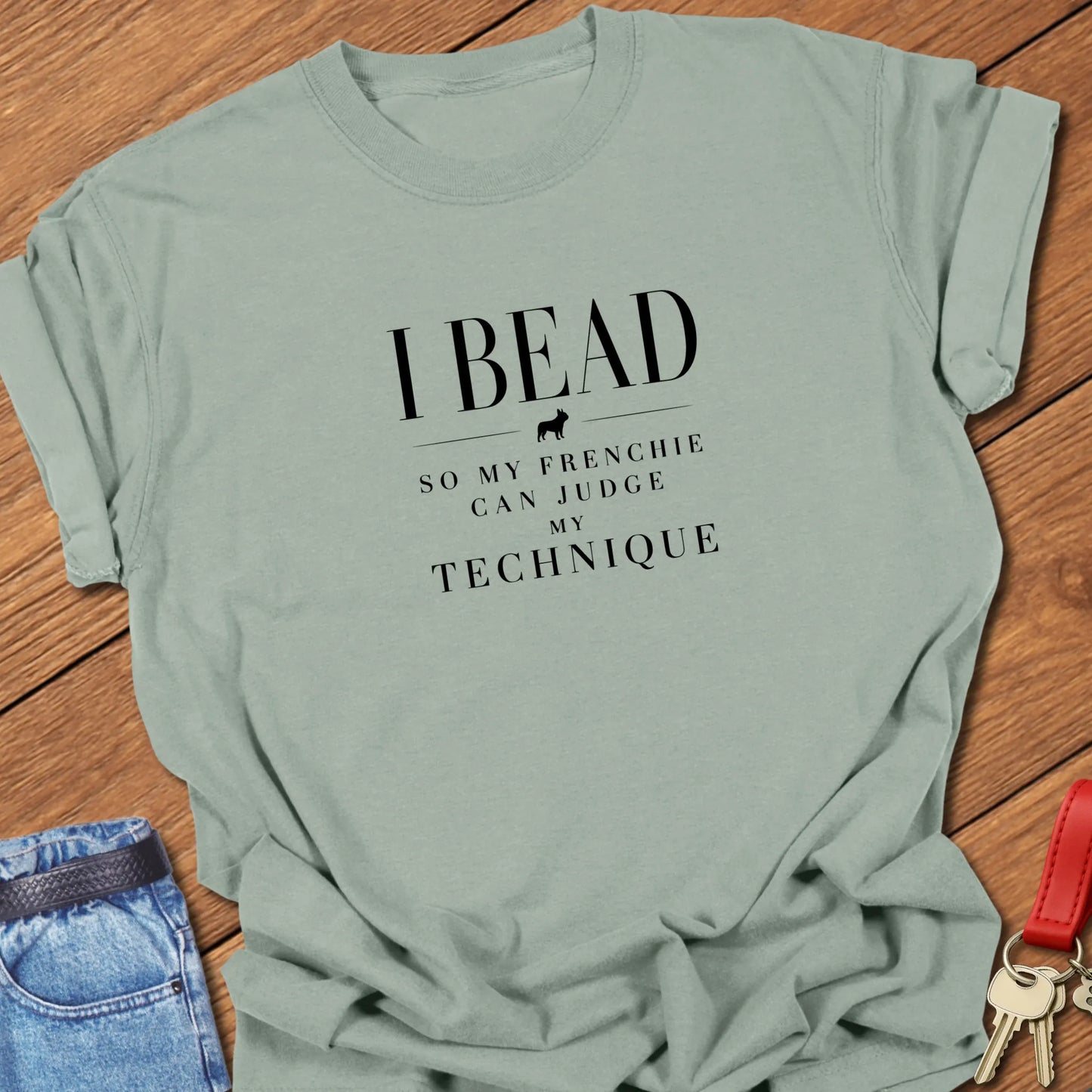 I Bead So My Frenchie Can Judge My Beading text design along with a French Bulldog silhouette on a Comfort Colors 1717 cotton t shirt in Bay color.