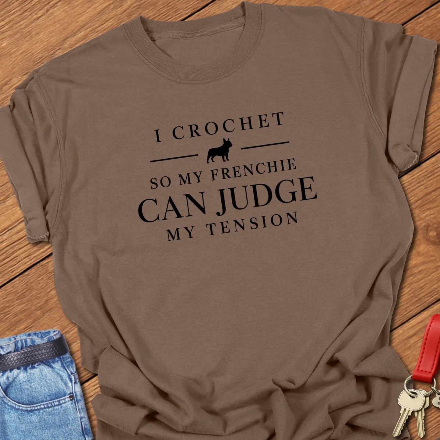 I Crochet So My Frenchie Can Judge My Tension text design featuring a French Bulldog silhouette on a Comfort Colors 1717 t shirt in Espresso color.