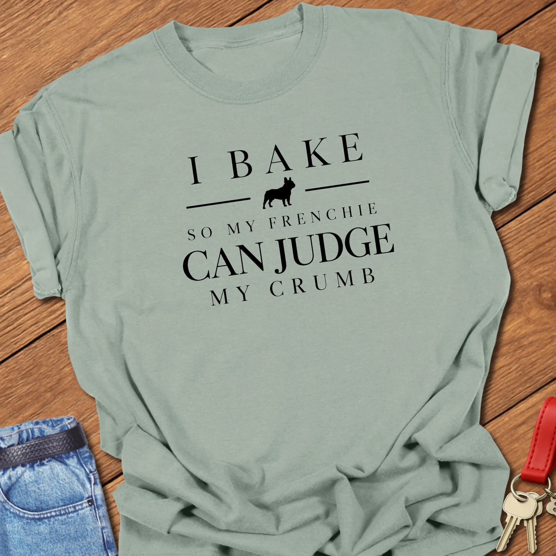 I Bake So My Frenchie Can Judge My Crumb text design along with a French Bulldog silhouette in Comfort Colors 1717 t shirt in Bay color.