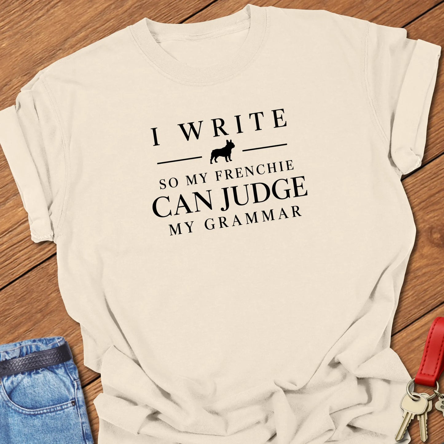 I Write So My Frenchie Can Judge My Grammar text design along with a French Bulldog silhouette on a Comfort Colors 1717 t shirt in Ivory color.