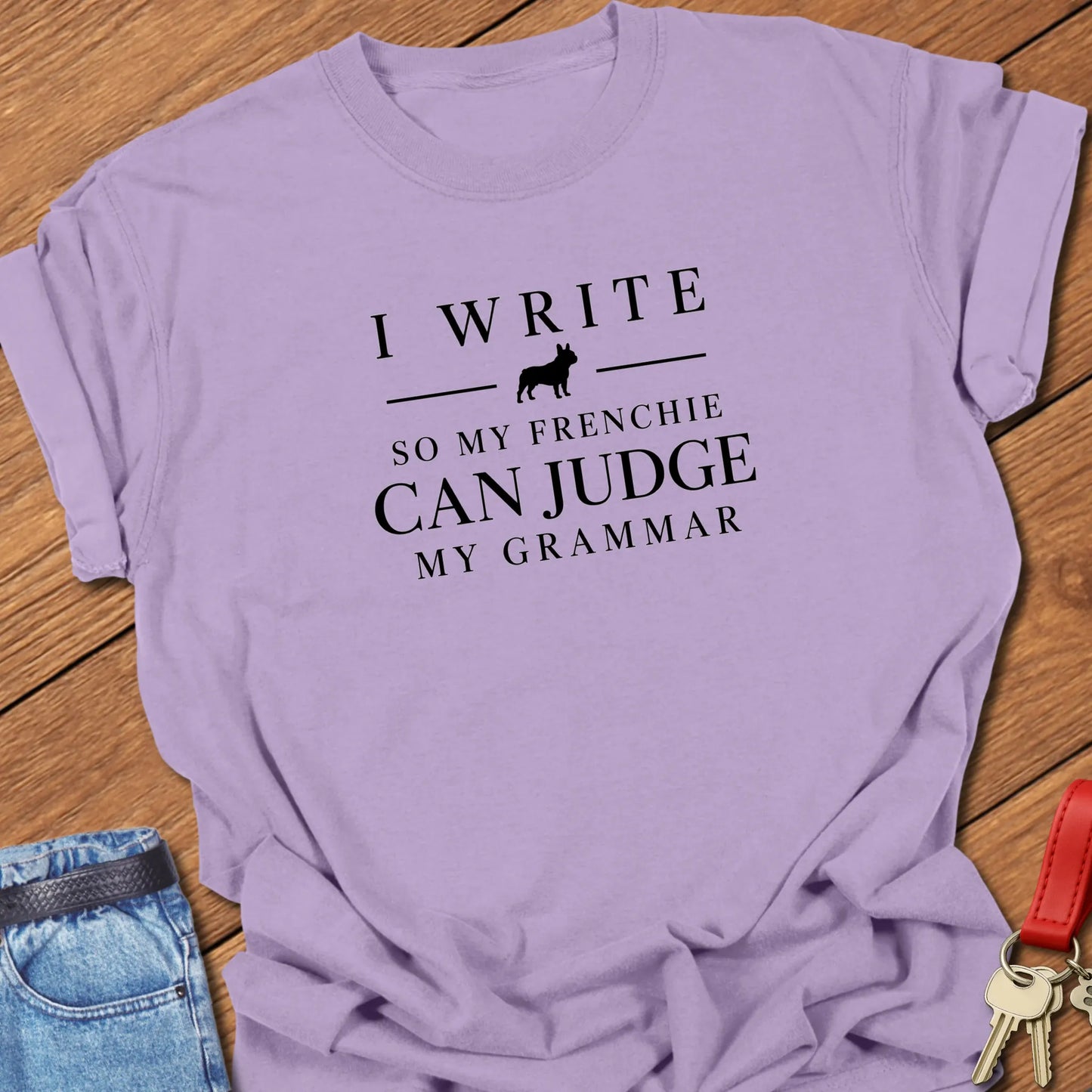 I Write So My Frenchie Can Judge My Grammar text design along with a French Bulldog silhouette on a Comfort Colors 1717 t shirt in Orchid color.