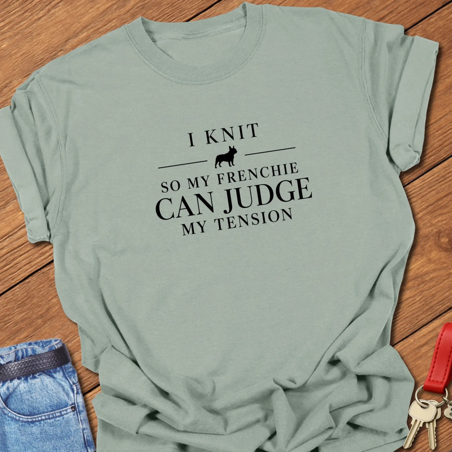 I Knit So My Frenchie Can Judge My Tension text design featuring a French Bulldog silhouette on a Comfort Colors 1717 t shirt in Bay design.