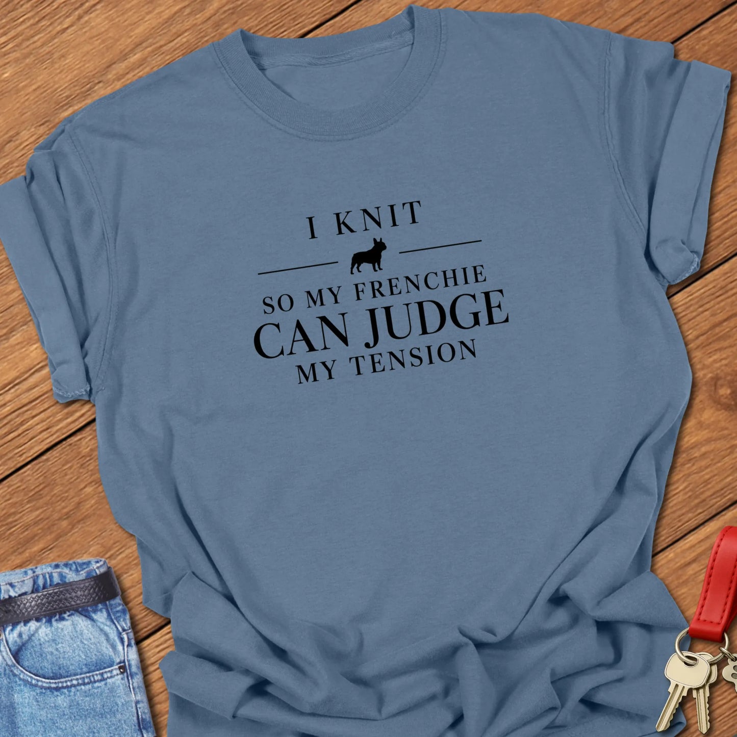 I Knit So My Frenchie Can Judge My Tension text design featuring a French Bulldog silhouette on a Comfort Colors 1717 t shirt in Blue Jean design.
