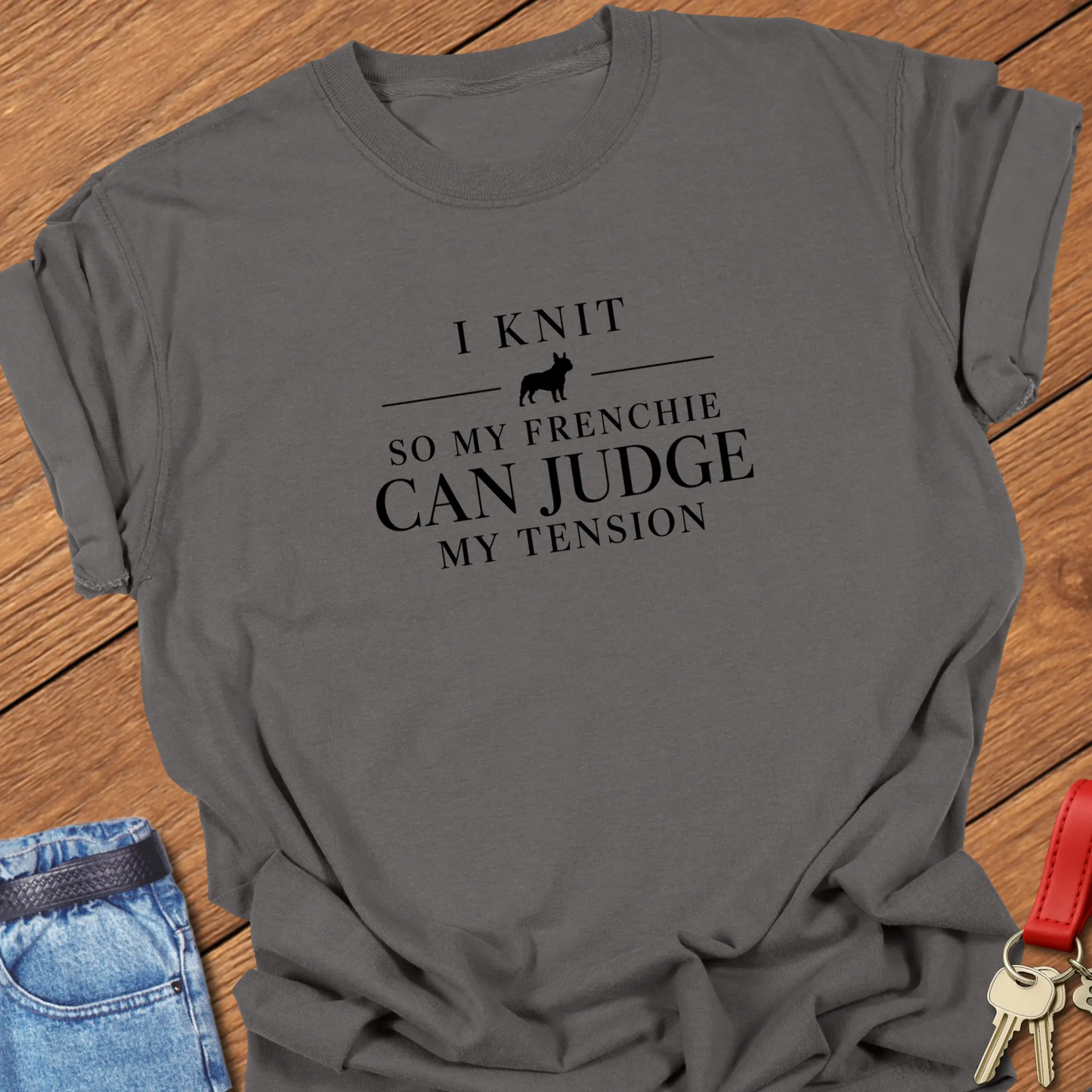 I Knit So My Frenchie Can Judge My Tension text design featuring a French Bulldog silhouette on a Comfort Colors 1717 t shirt in Pepper design.