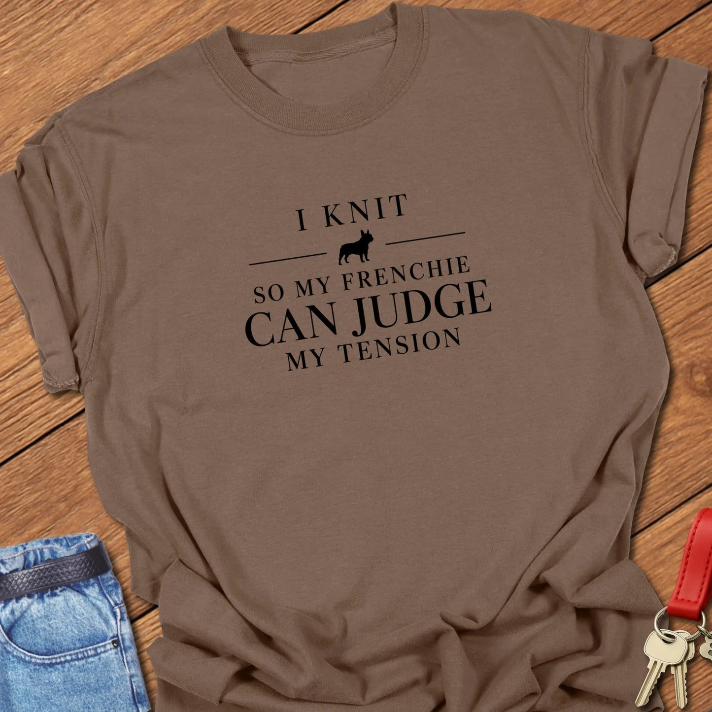 I Knit So My Frenchie Can Judge My Tension text design featuring a French Bulldog silhouette on a Comfort Colors 1717 t shirt in Espresso design.