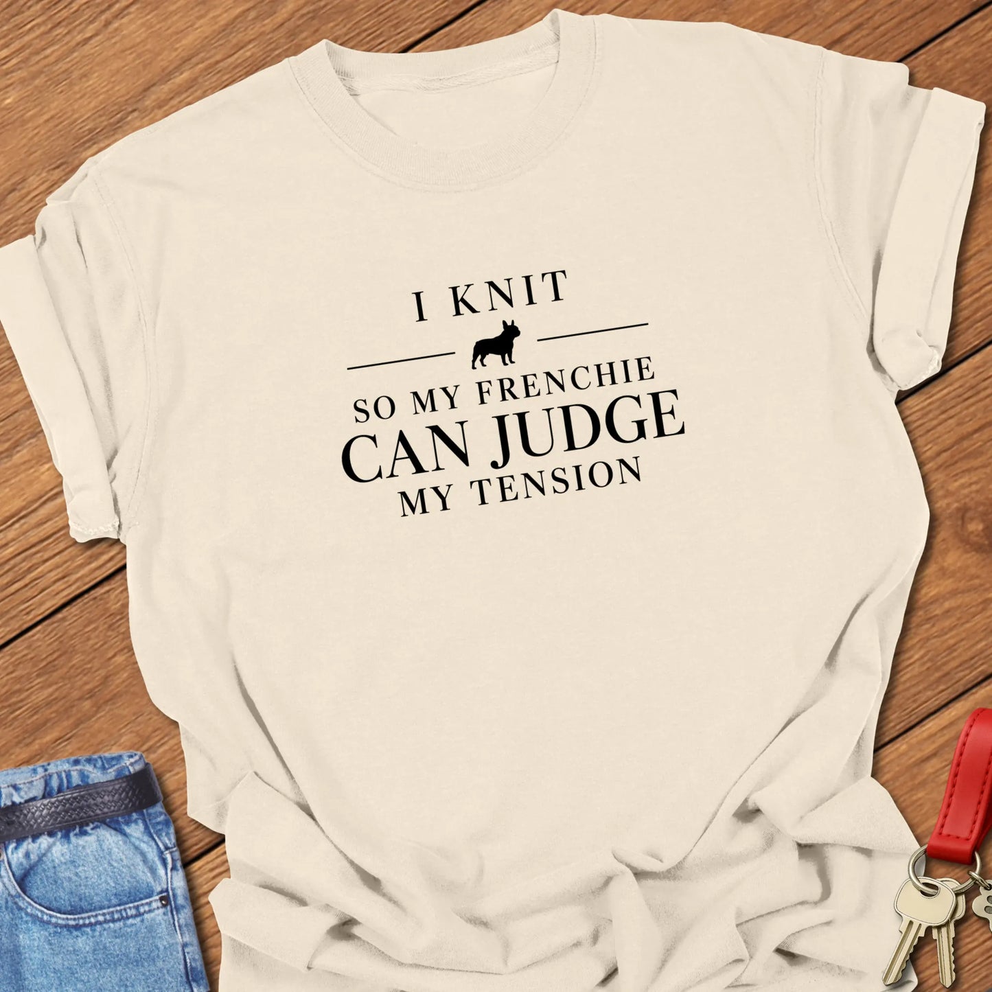 I Knit So My Frenchie Can Judge My Tension text design featuring a French Bulldog silhouette on a Comfort Colors 1717 t shirt in Ivory design.