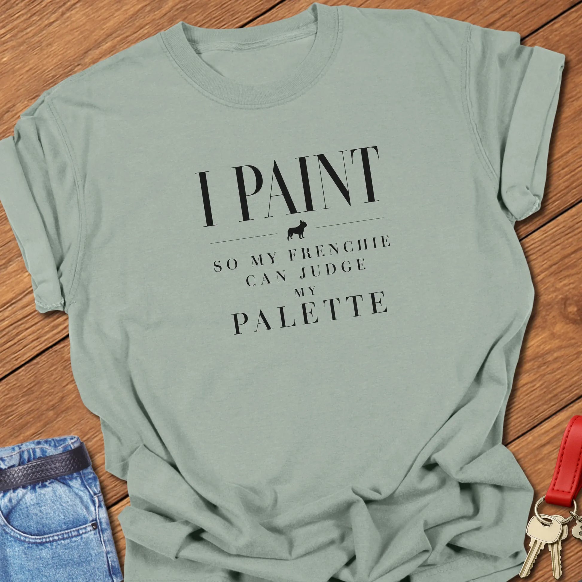 I Paint So My Frenchie Can Judge My Palette text design along with a French Bulldog silhouette on a Comfort Colors 1717 t shirt in Bay color.