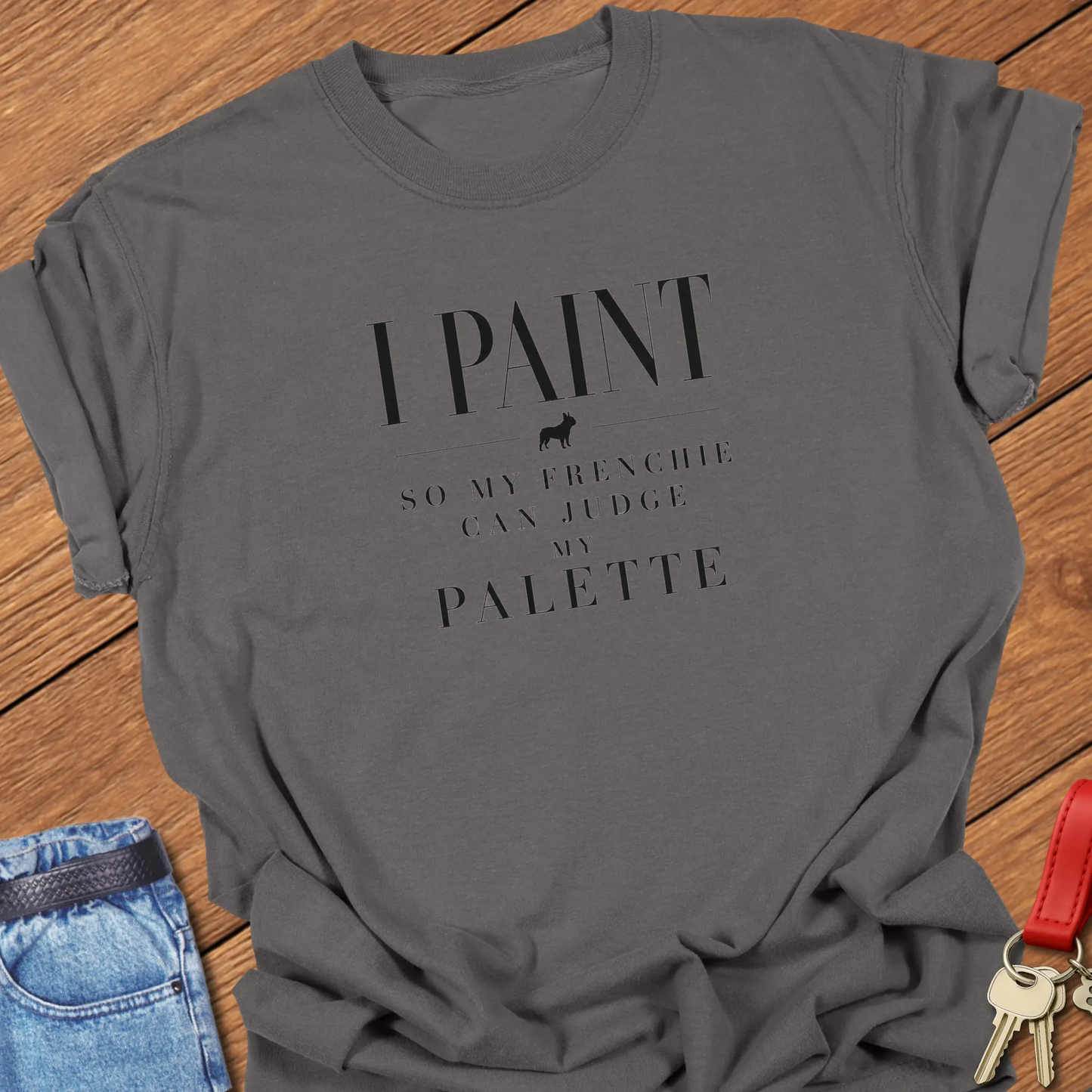 I Paint So My Frenchie Can Judge My Palette text design along with a French Bulldog silhouette on a Comfort Colors 1717 t shirt in Pepper color.