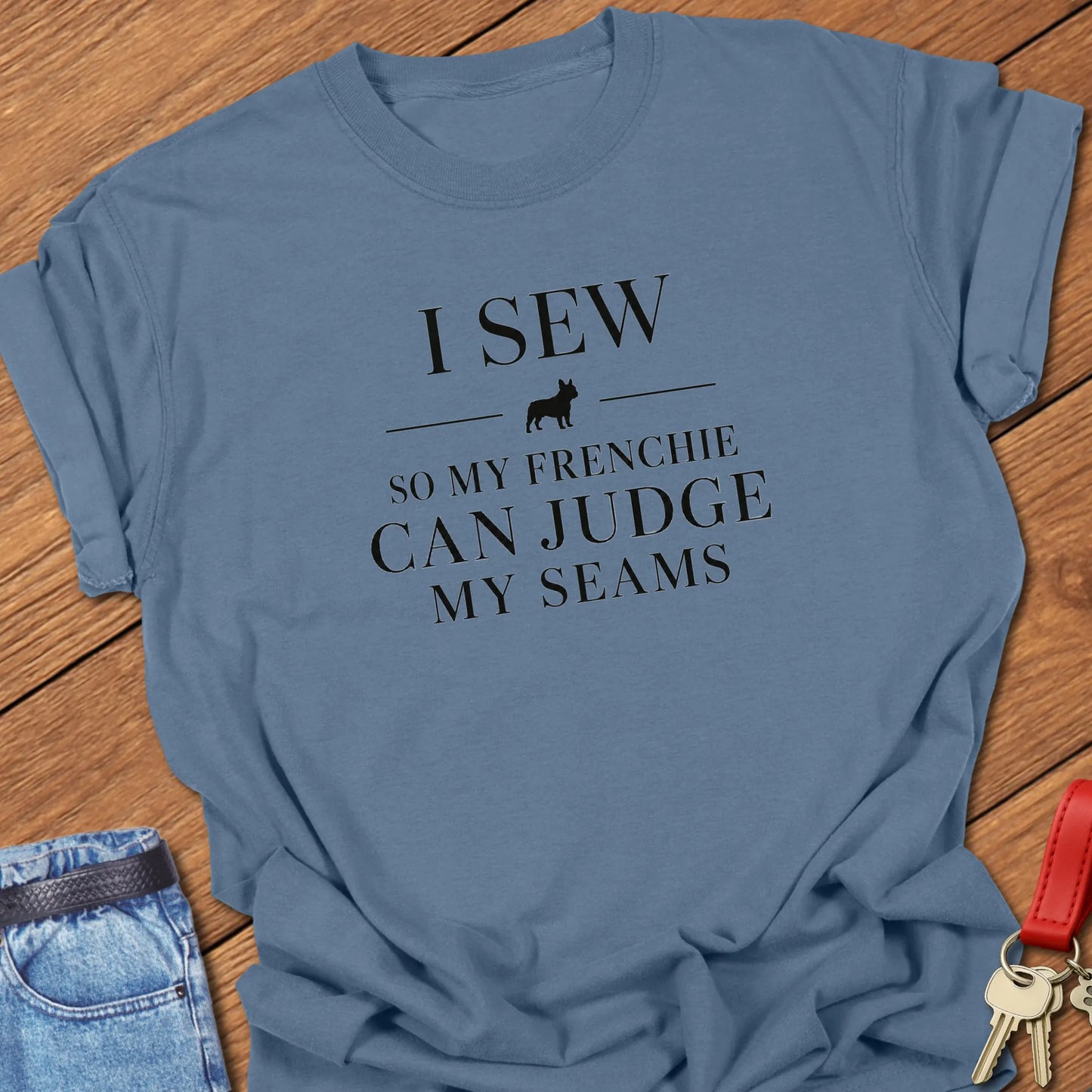 I Sew So My Frenchie Can Judge My Seams text design along with a French Bulldog silhouette on a Comfort Colors 1717 t shirt in Blue Jean color.
