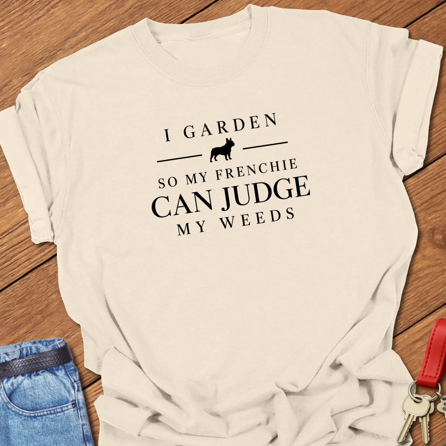 I Garden So My Frenchie Can Judge My Weeds text design along with a French Bulldog silhouette on a Comfort Colors 1717 t shirt in Ivory color.
