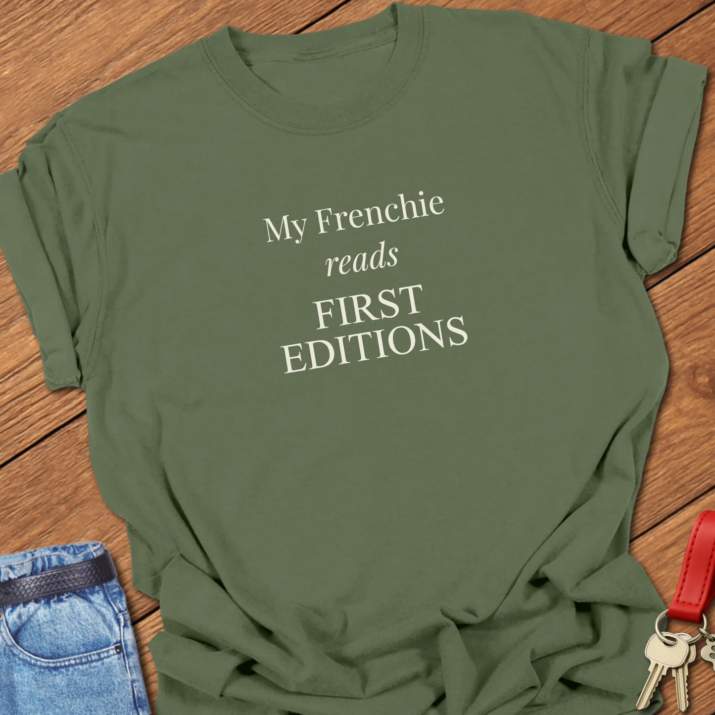 My Frenchie Reads First Editions French Bulldog t-shirt in Moss displayed on a Comfort Colors® garment-dyed shirt featuring elegant serif typography.
