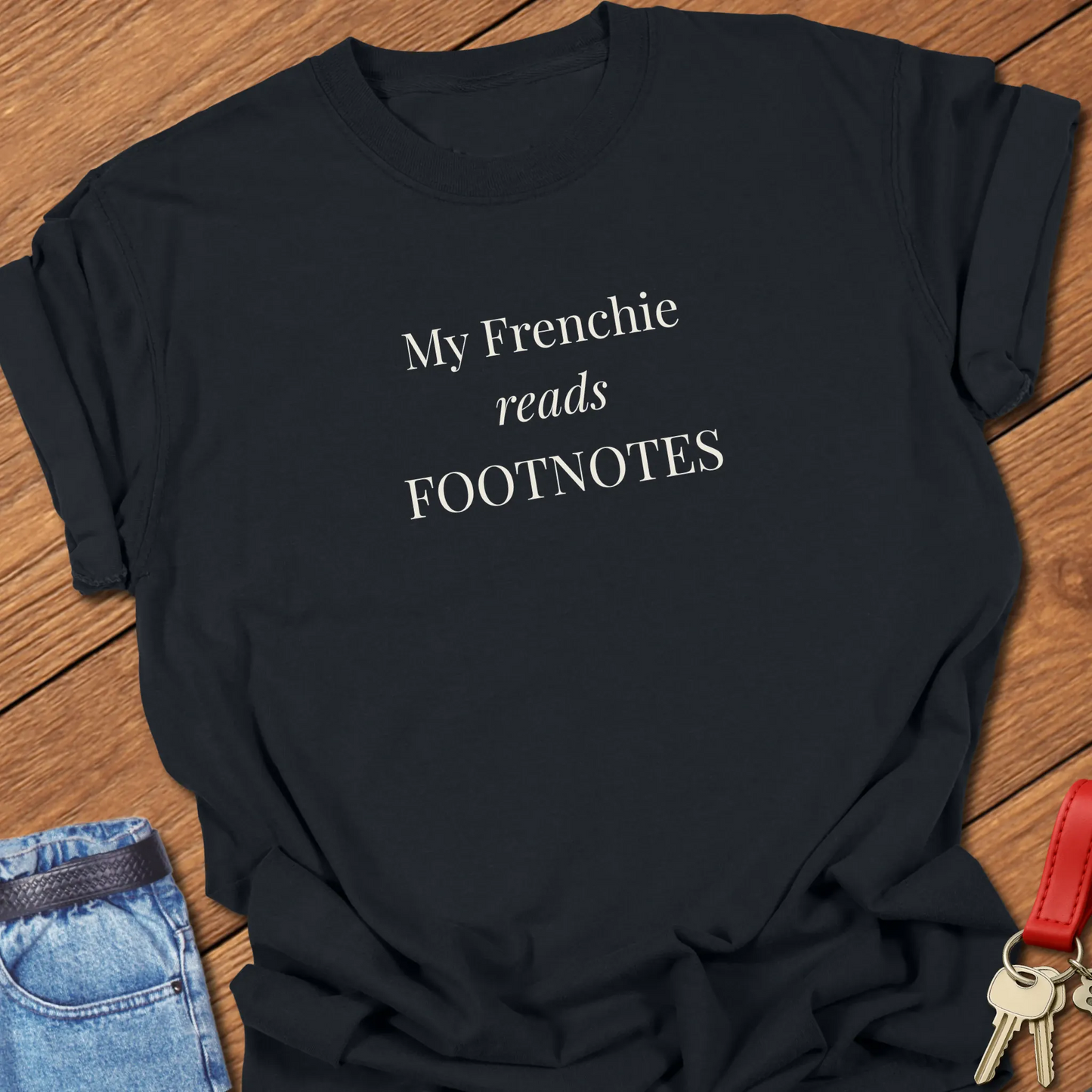 A funny Comfort Colors® garment-dyed shirt in Black  featuring elegant serif typography with the phrase "My Frenchie Reads Footnotes."