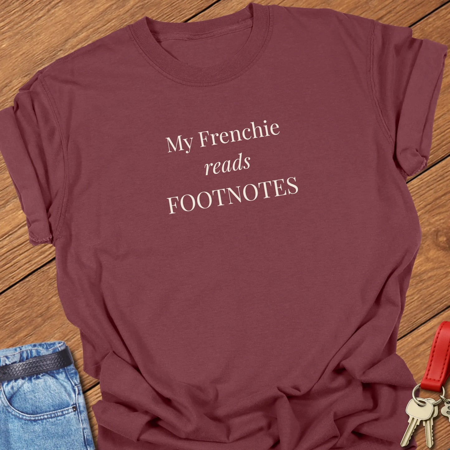 A funny Comfort Colors® garment-dyed shirt in Brick  featuring elegant serif typography with the phrase "My Frenchie Reads Footnotes."
