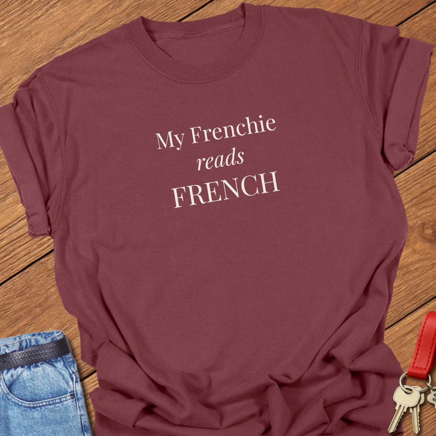 A Comfort Colors® garment-dyed shirt in Brick featuring a popular retro typewritter font featuring the funny slogan "My Frenchie Reads French."