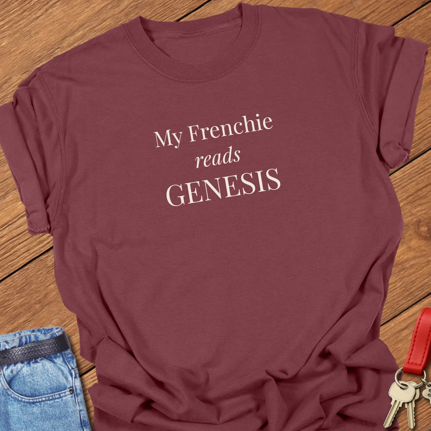 My Frenchie Reads Genesis French Bulldog t-shirt displayed on a Brick Comfort Colors® garment-dyed shirt featuring elegant serif typography.
