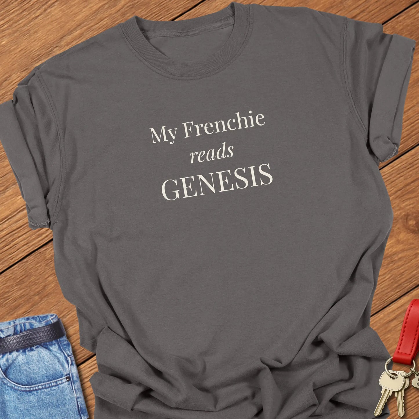 My Frenchie Reads Genesis French Bulldog t-shirt displayed on a Pepper 
Comfort Colors® garment-dyed shirt featuring elegant serif typography.