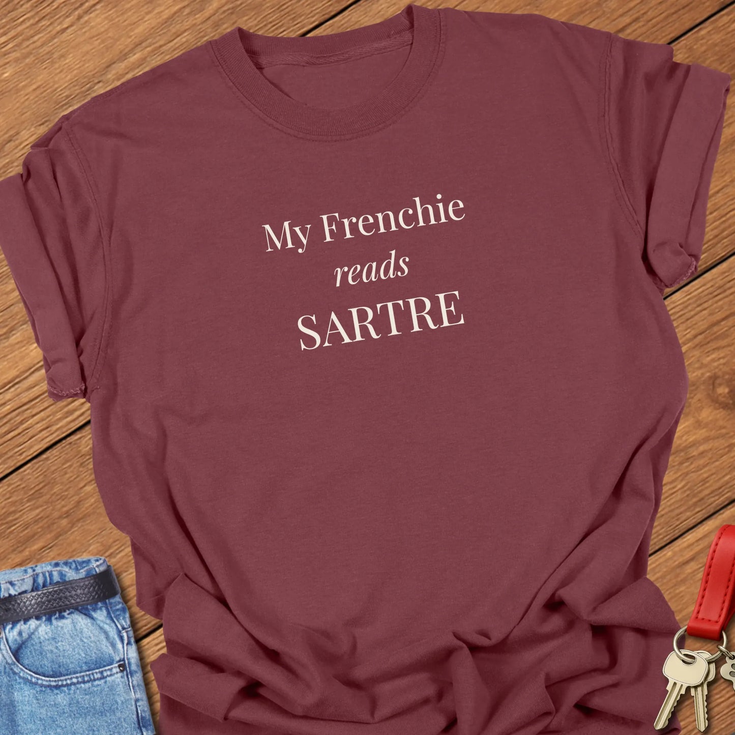 A funny Comfort Colors® garment-dyed shirt with elegant serif typography that says My Frenchie Reads Sartre in brick.