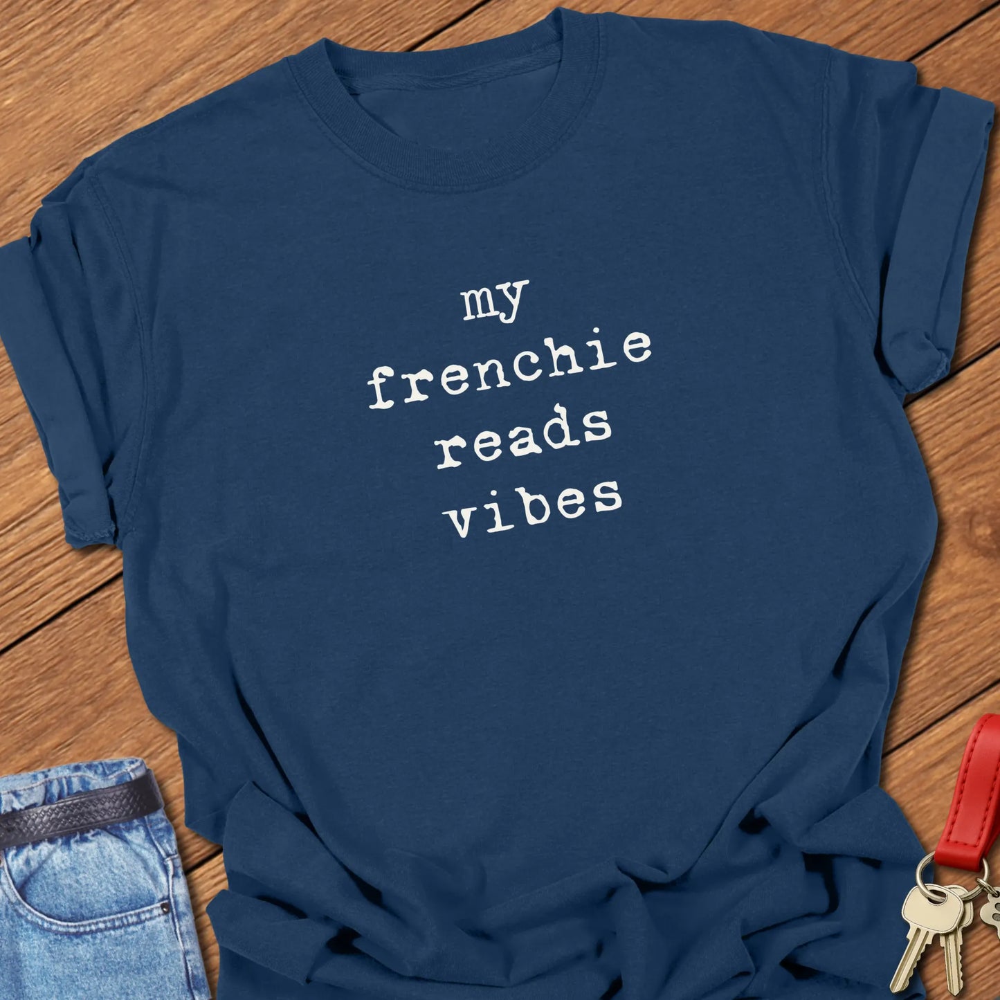 Typewriter-style typography featuring the slogan "My Frenchie Reads Vibes" printed on a Comfort Colors® garment-dyed t-shirt in True Navy color.