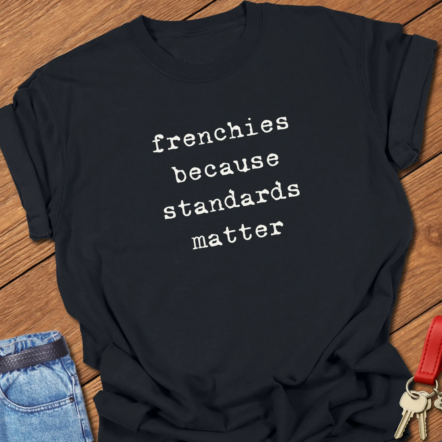 Typewriter-style typography featuring the slogan "Frenchies Because Standards Matter" printed on a Comfort Colors® garment-dyed t-shirt in Black color.